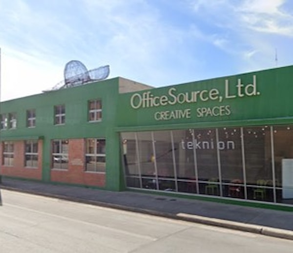 A building with a green facade and a sign that says OfficeSource, Ltd.